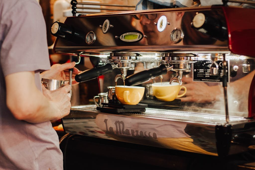 Barista in busy cafe dublin 8 espresso machine to brew coffee in a café, showcasing coffee preparation process.